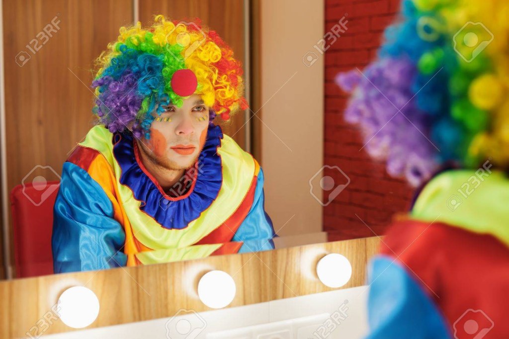 Picture of: Circus Clown Looks In A Mirror In A Make-up Room